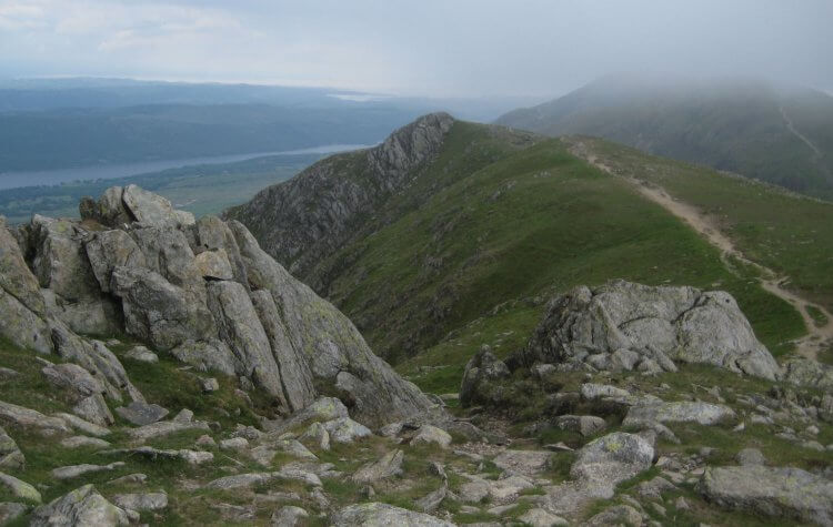Path along the mountain tops with Coniston summit shrouded in mist